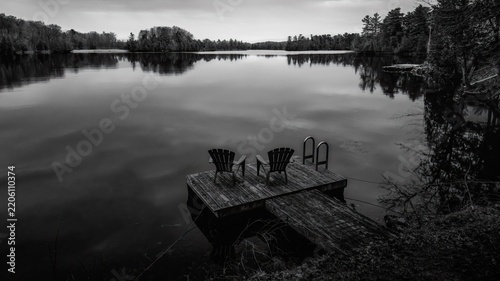 BW-This serene landscape during sunrise across Rideua Lakes area captures the quiet stillness of Benson Lake in South Frontenac, Ontario, Canada