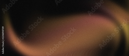 Abstract dark background with soft flowing orange and yellow light waves and grainy texture