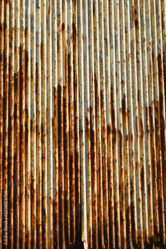 Texture or background of Rusted, aged galvanized sheet metal wall surface; weathered galvanized steel fence; retro concept; the artistry of old, rusty galvanized sheeting; vintage-style metal panels.