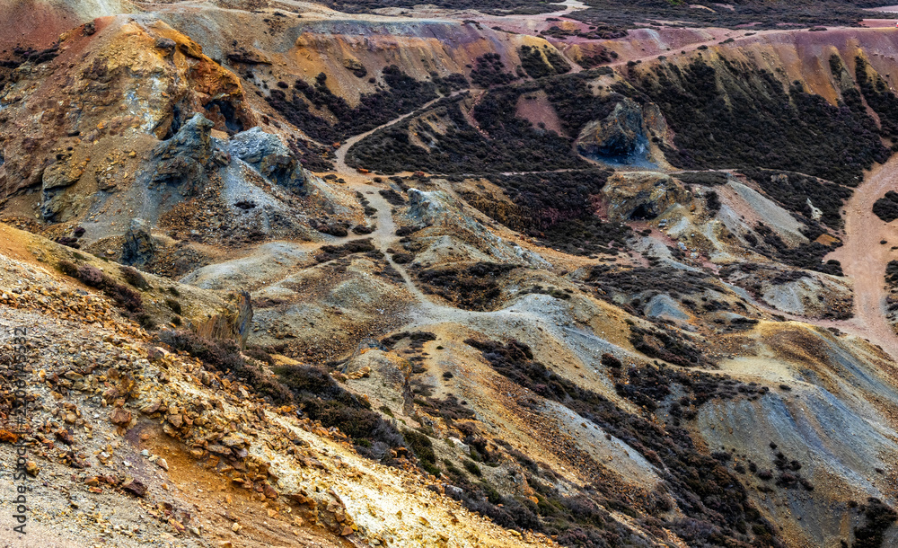 Obraz premium Colorful mineral soil and vibrant quarry rock formations at Parys Mountain copper mine