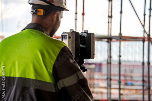 Worker wears high-visibility vest and hard hat