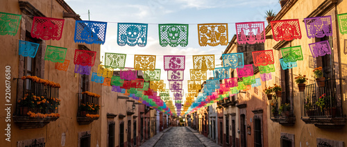 Colorful Mexican papel picado banner, multicolored perforated paper flags, Hispanic folk decoration, fiesta garland, traditional festival background
