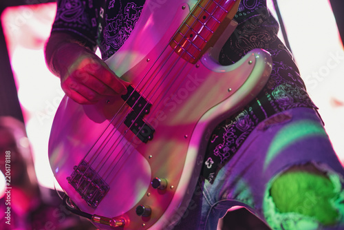 Bass guitarist performing on stage with passion