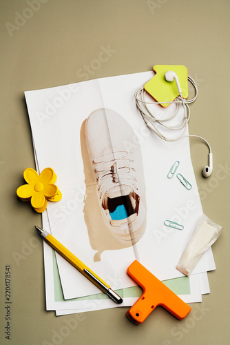 Scattered daily objects and  stationery on sneaker photo
