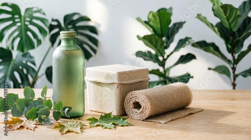 Eco Friendly Packaging with Green Bottle and Burlap Roll on Wooden Table for Sustainable Marketing