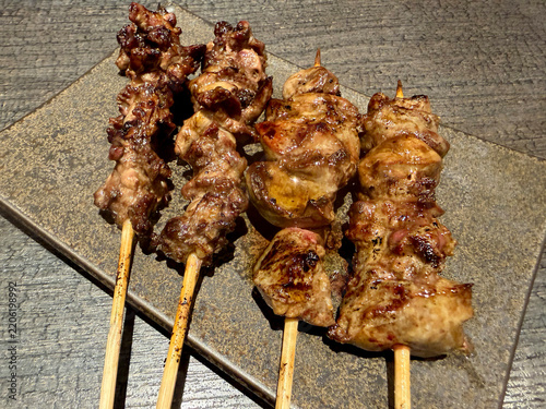 Japanese Yakitori Grilled Chicken Skewers on a Ceramic Plate