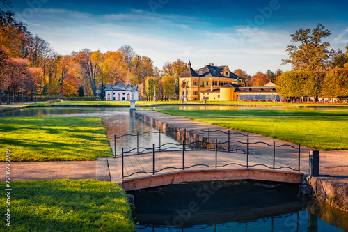 Sunny autumn view of Hellbrunn castle, Austria, Europe. Colorful morning cityscape of Morzg, district of Salzburg city, Austria, Europe. Traveling concept background.