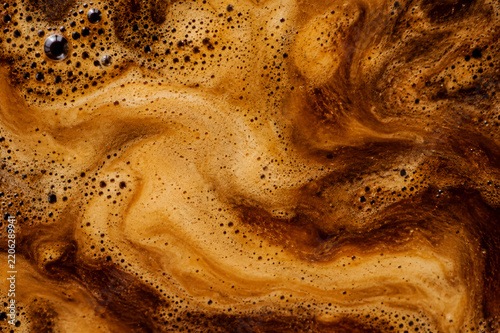 Abstract top view of fresh espresso coffee crema texture with foam and bubbles