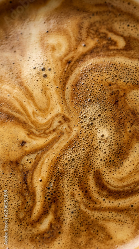 Abstract top view of fresh espresso coffee crema texture with foam and bubbles