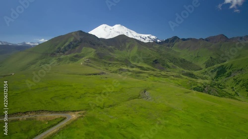 A beautiful view of the snow-capped peaks of Mount Elbrus (elevation 5,642 m). The landscape and nature of the North Caucasus.