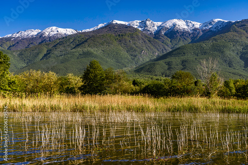 Lake Kerkini in spring, with the snow-capped peaks of the Belles mountain range (also known as Belasica or Kerkini) towering in the background. Greece, Central Macedonia
