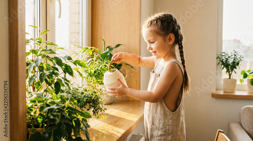 Young Girl Watering Houseplants at Home