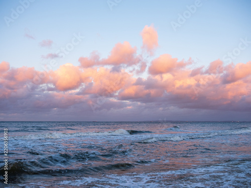 Pink clouds over the Baltic Sea at dusk