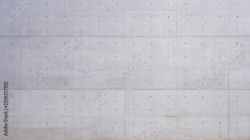 Gray exposed concrete wall texture with tie holes