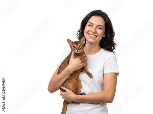Smiling woman holding cat white background studio portrait