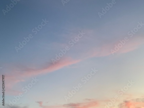 Canvas Print Pastel pink clouds across soft blue evening sky