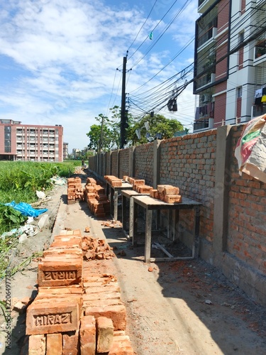 urban construction site with brick wall and unfinished building