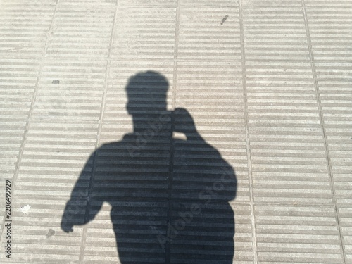 silhouette of a person behind window blinds