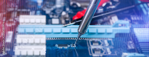 Precision Soldering Iron Repairing Electronic Circuit Board with Microchip Components in Technology Workshop