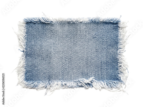 Blue denim fabric patch with frayed edges isolated cutout