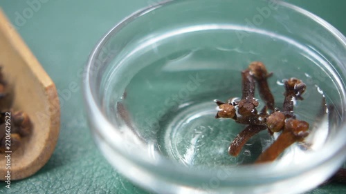 Cloves soaking in water for preparation and use in cooking