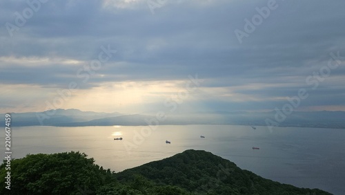 Sunlight breaking through clouds over the sea, viewed from Mount Hakodate, Japan