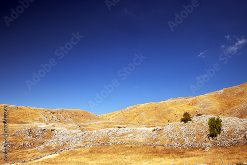 Golden Karst Mountains Under Deep Blue Sky in a Remote Summer Landscape, Bjelasnica, Bosnia and Herzegovina