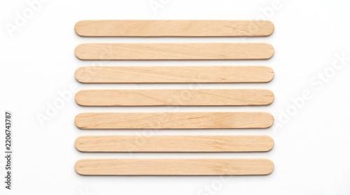 Seven Flat Wooden Craft Sticks in a Row Isolated on White Background