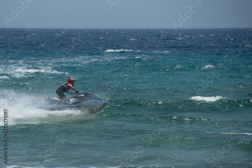 Jet skiing sport on rough waters with splashes and waves