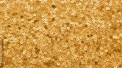 Abstract background of shiny gold sequins creating a glamorous textured pattern.