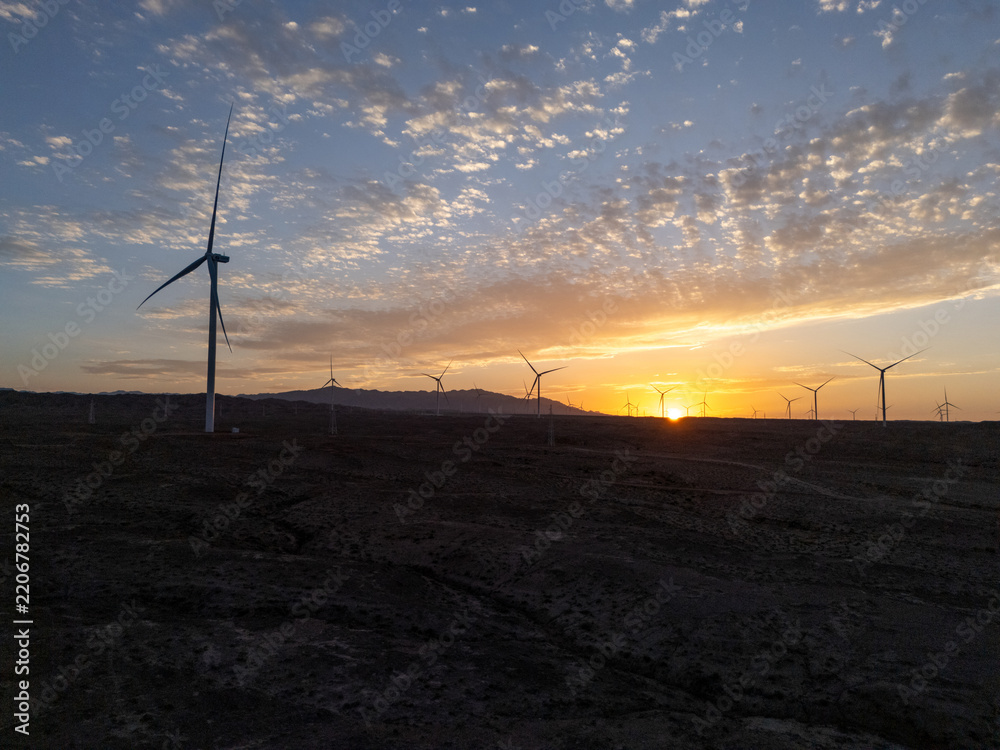 Obraz premium silhouette of wind turbines at sunset
