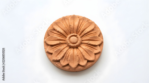 Terracotta rosette displays a floral relief design suitable for architectural restoration projects.
