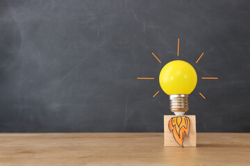 Education concept image. Creative idea and innovation. light bulb metaphor over blackboard background