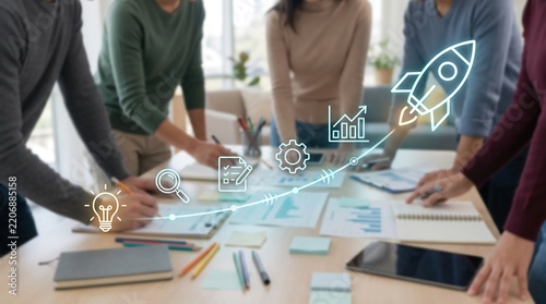 Strategic business planning session with startup growth icons and rocket symbol overlay as diverse professional team collaborates around conference table with charts and documents