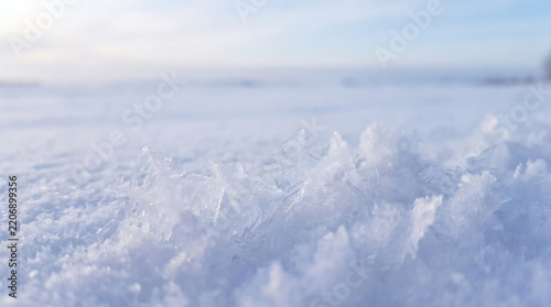Macro shot of ice crystals on snowy ground in winter