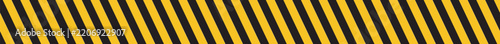 Yellow and black diagonal hazard warning stripes, seamless caution tape border and long industrial safety barrier ribbon