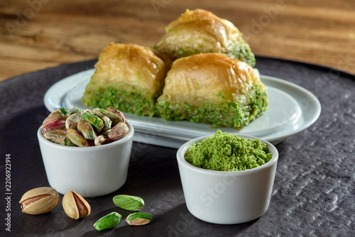 Delicious authentic Turkish dessert baklava with pistachio filling and nuts served on a plate