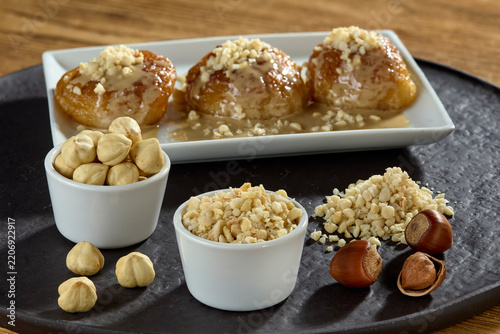 Delicious authentic Turkish syrupy dessert with tahini and chopped hazelnuts