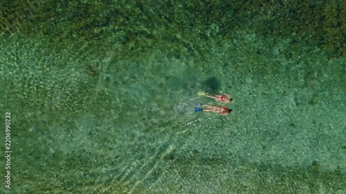 Young female couple snorkeling together in clear turquoise waters off Coiba Island, Panama, exploring vibrant coral reef life - stock video