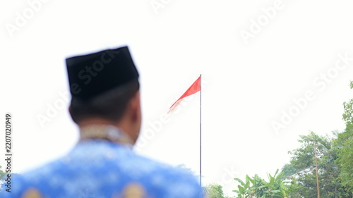 Fotografie Civil servants wearing KORPRI uniforms are saluting the flag during the KORPRI Day commemoration ceremony
