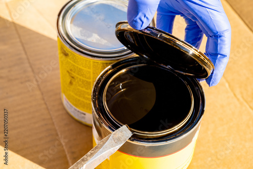 Screw driver used to open a can of wood stain