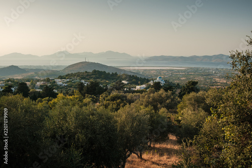 A view from the mountain village of Zia of small traditional houses with the sea in the background at sunset on the island of Kos.