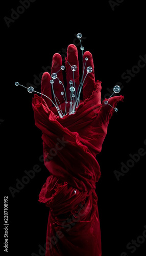 Red Fabric Hand with Neon Drops for World AIDS Day Awareness Concept