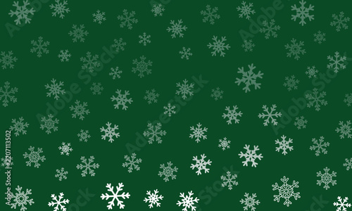 Green Christmas background with scattered white snowflakes, a festive winter pattern.