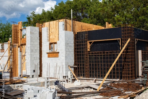 Steel rebar reinforcement cage and wooden formwork framing a concrete wall installation at a modern construction site