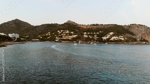 Coastal town with sailboats and resort buildings