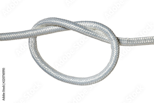 White braided synthetic rope overhand knot close up detail