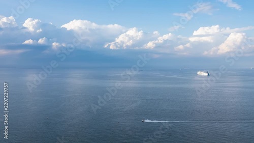 Aerial Hyperlapse: Calm Blue Ocean with Ships and Jet Ski Under a Vibrant Sky