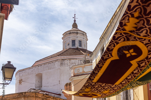 Cultural Fusion: Christian Church Dome and Moorish Awning during Almossassa Festival in Badajoz, Extremadura, Spain.