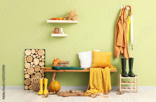 Autumn home interior, cozy entryway decor with pumpkins and warm textiles for...